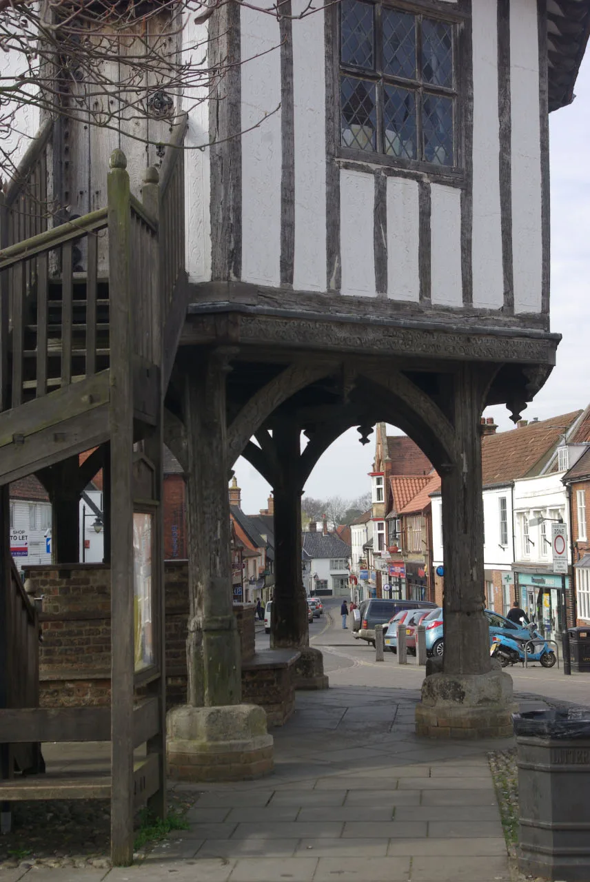 Wymondham town centre seen through the Market Cross, photographed in an earlier year. The photo does not show any incident in the figures